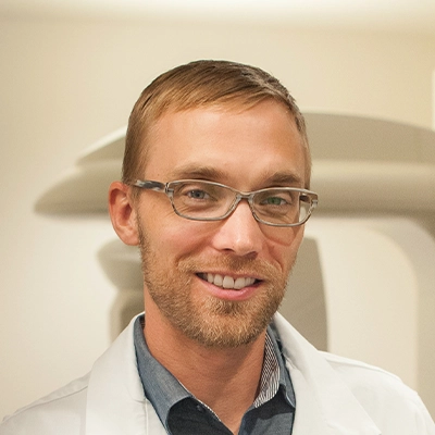 A headshot photo of oral surgeon Brenen Olsen