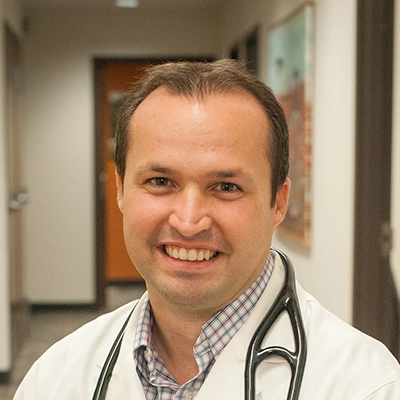 A headshot photo of oral surgeon Brenen Olsen