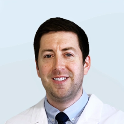 A headshot photo of oral surgeon Brenen Olsen